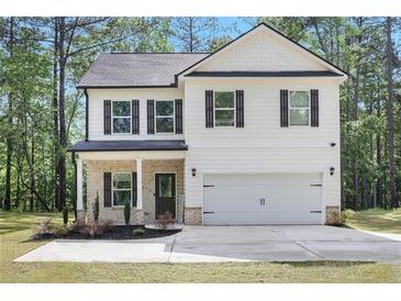 Charming two-story home with white siding, black shutters, and attached two car garage at 115 Haven Brook Way, Douglasville, GA 30134