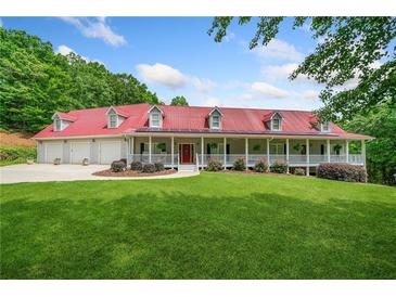 Stunning home with a red roof, wraparound porch, and well-manicured lawn at 425 Chadwick Pl, Canton, GA 30114