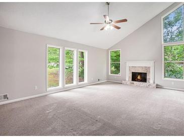 Bright living room boasts a fireplace, vaulted ceilings and large windows at 3006 Alberta Dr, Marietta, GA 30062