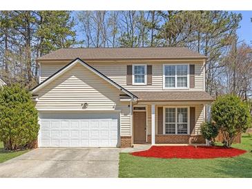 Charming two-story home with a well-maintained lawn and attached two-car garage at 145 Silver Mine Trl, Austell, GA 30168