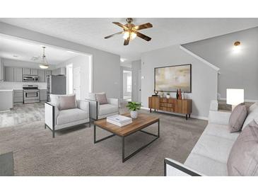 Bright living room showcases neutral tones, an open floorplan, and a ceiling fan at 145 Silver Mine Trl, Austell, GA 30168