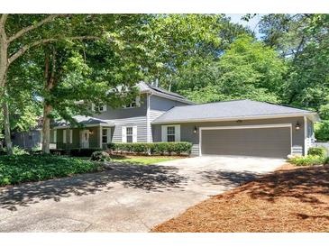 Charming gray two-story home with well-manicured lawn and two car garage at 3544 Chestatee Dr, Marietta, GA 30062