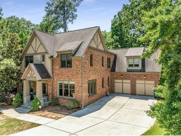 Charming brick two-story home with well-manicured lawn, mature trees and a three car garage at 504 S Westminster Ne Way, Atlanta, GA 30307
