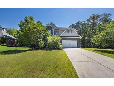 Charming two-story home with a well-manicured lawn and an inviting facade at 6645 Crest Wood Ln, Douglasville, GA 30135