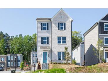 Charming two-story home with a combination of white brick and gray siding, complemented by a bright blue front door at 624 Devon Aly, Acworth, GA 30102