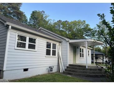 Charming exterior view of home featuring gray siding, a covered front porch, and well-maintained landscaping at 3831 Dillard St, Powder Springs, GA 30127