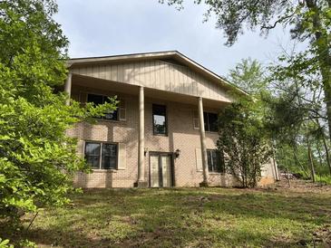Suburban two-story home featuring a brick facade, large columns, and a well-maintained front lawn at 2831 Bettis Ct, Marietta, GA 30066