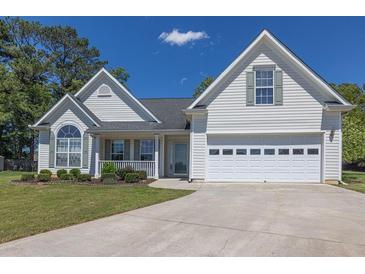 Charming two-story home with well-manicured lawn, attached garage, and inviting front porch at 2780 Matlin Way, Buford, GA 30519