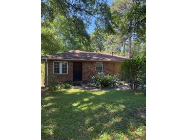 Charming brick home with inviting curb appeal and mature landscaping at 309 E Rhinehill E Rd, Atlanta, GA 30315