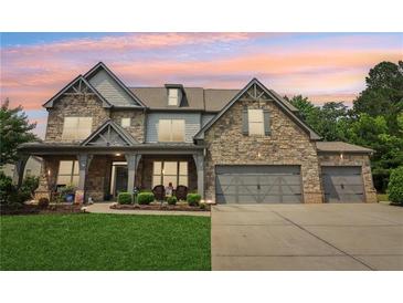 Charming two-story home with a stone facade, covered porch and a spacious three-car garage at 776 Amos Ln, Kennesaw, GA 30152