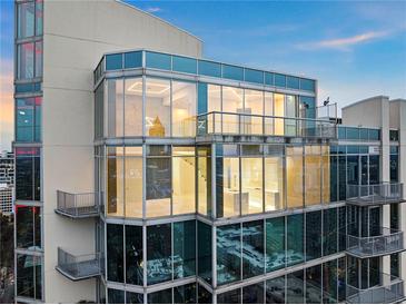 Modern condo exterior featuring floor to ceiling windows and balconies with views of the city skyline at 860 Peachtree Ne St # 2801, Atlanta, GA 30308