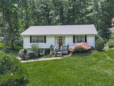 Charming single-story home featuring a lush lawn and welcoming front porch entrance at 301 Jetta Ln, Canton, GA 30115
