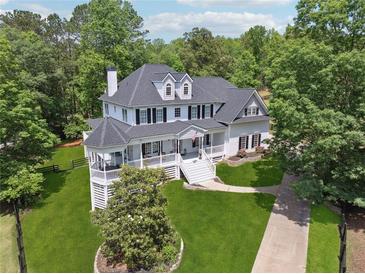Stunning two-story home with a white exterior, black shutters, and a welcoming front porch at 471 Henderson Lake Dr, Canton, GA 30115