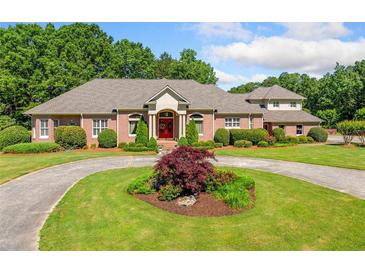 Stunning brick home features circular driveway and meticulously manicured landscaping at 226 Euharlee Five Forks Rd, Kingston, GA 30145