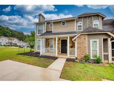 Charming two-story home with a black front door, stone accents, and a well-manicured lawn at 924 Park Gate Pl, Stone Mountain, GA 30083