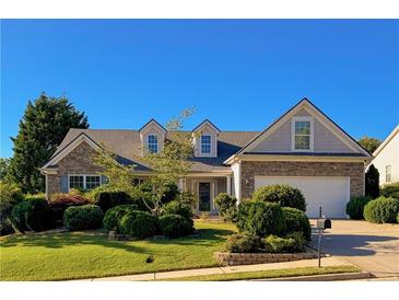 Charming home featuring a stone-accented facade, manicured landscaping, and a welcoming two-car garage at 2642 Colleen Ln, Dacula, GA 30019