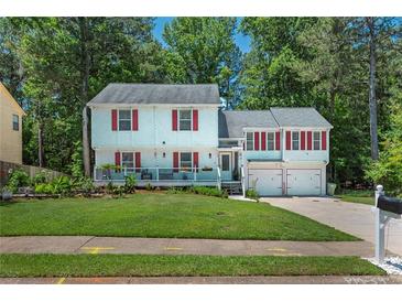 Charming two-story home featuring a covered front porch, red shutters, and a well-manicured lawn at 3856 Nowlin Nw Rd, Kennesaw, GA 30144