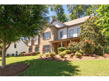 Charming two-story home featuring a combination of stone and siding with a beautifully landscaped front yard at 2470 Anderson Estates Ct, Marietta, GA 30064