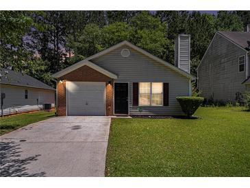 Charming single-story home with well-maintained lawn and attached one-car garage at 4378 Chestnut Oaks Trce, Lithonia, GA 30038