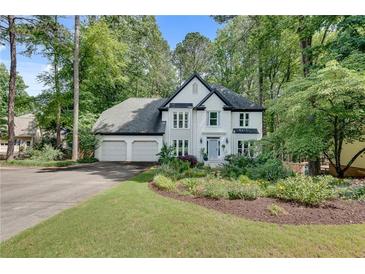 Charming two-story home with three-car garage and beautifully landscaped front yard at 3250 Cobbs Farm Nw Trl, Marietta, GA 30064