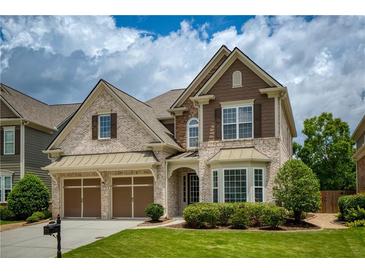 Charming two-story home featuring a well-manicured lawn and a two-car garage at 4652 Prater Se Way, Smyrna, GA 30080