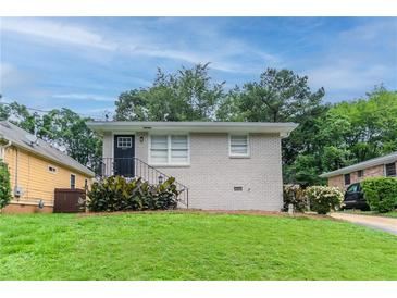 Charming single-story home with a well-manicured lawn and lush landscaping at 933 Capitol View Nw Ave, Atlanta, GA 30318