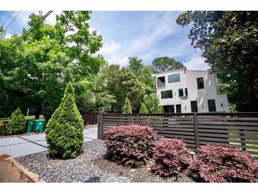 Modern two-story home featuring a horizontal wood fence and lush landscaping at 1099 Vista Ne Trl, Atlanta, GA 30324