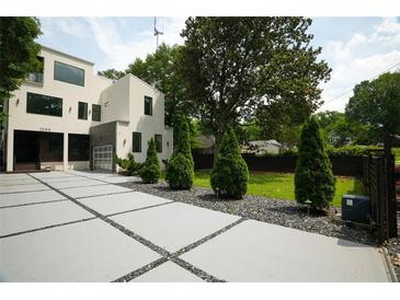 Striking modern home with a unique driveway and meticulously manicured landscaping at 1099 Vista Ne Trl, Atlanta, GA 30324