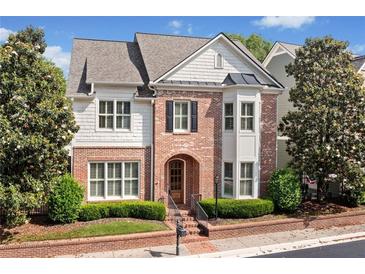 Charming brick home with manicured landscaping, symmetrical design, and a welcoming arched entryway at 255 Kendemere Pointe, Roswell, GA 30075