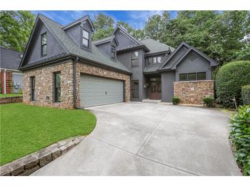 Stunning home features a stone facade, a gray color scheme and attached two-car garage at 2255 Lenox Ridge Ne Ct, Atlanta, GA 30319