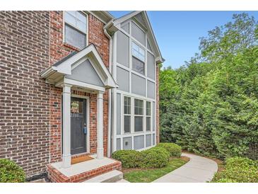 Charming brick home with a covered entryway and well-maintained landscaping at 2300 Whiteoak Drive Southeast Se Dr, Smyrna, GA 30080