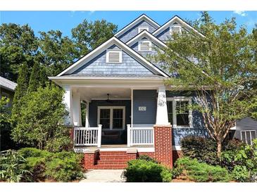 Charming two-story home with a covered front porch and beautifully landscaped front yard at 132 Olympic Pl, Decatur, GA 30030