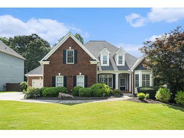 Beautiful red brick home with a well-manicured lawn and mature landscaping at 402 Lake Point Trce, Canton, GA 30114