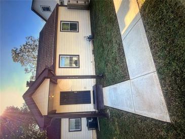 Charming home featuring a covered porch and a well-manicured front yard, complete with a concrete walkway leading to the entrance at 1132 Se Oak Knoll Se Ter, Atlanta, GA 30315