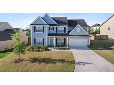Charming two-story home featuring a well-manicured lawn and a two-car garage at 55 Clubhouse Way, Acworth, GA 30101