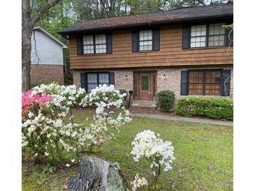 Charming two-story home with well-maintained lawn, blossoming azaleas and a welcoming front entrance at 3352 Northbrook Dr, Atlanta, GA 30340