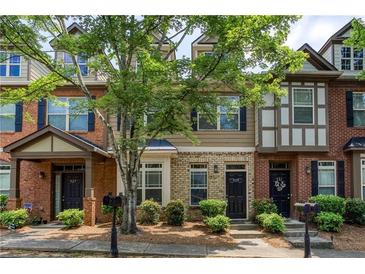 Charming townhomes with brick and siding exteriors, landscaped front yards, and inviting entrances at 529 Ridge View Crossing Xing, Woodstock, GA 30188