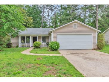 Charming single-story home featuring a well-maintained lawn and attached two-car garage at 744 Martin Rd, Stone Mountain, GA 30088