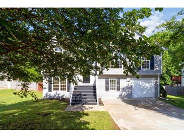 Charming two-story home with gray siding, black shutters, and a well-manicured front yard at 7186 Raintree Loop, Jonesboro, GA 30236