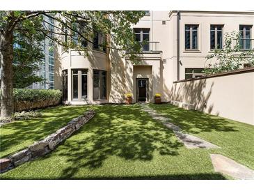 Beautiful backyard with lush green grass, stone pavers, and flower pots adding charm to the property at 3376 Peachtree Rd # 1, Atlanta, GA 30326