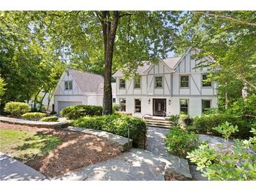 Charming two-story home featuring a well-manicured front yard and a brick exterior at 55 Bransford Rd, Sandy Springs, GA 30324