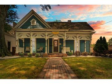 Charming home with a beautiful front porch and a well-maintained lawn and brick path, great curb appeal at 429 Oakland Ave, Atlanta, GA 30312