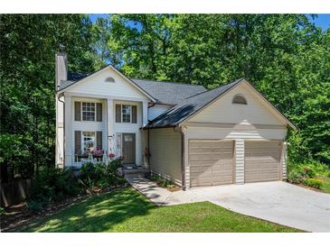 Charming two-story home featuring a two-car garage, well-manicured lawn, and a welcoming front porch at 3006 Durban Ct, Decatur, GA 30034