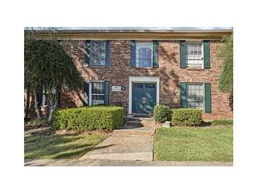 Charming brick apartment building featuring a manicured lawn and inviting front entrance at 5560 Kingsport Ne Dr # 27, Atlanta, GA 30342