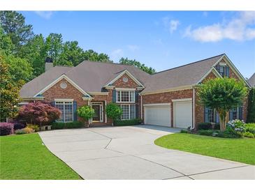 Beautiful brick home featuring manicured landscaping, a spacious driveway, and an attached two-car garage at 4115 Gold Mill Rdg, Canton, GA 30114