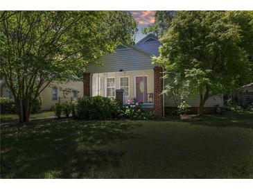 Charming home featuring a screened porch, brick pillars, lovely landscaping and a well-manicured lawn at 1834 Broad Ave, Atlanta, GA 30344