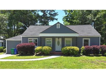 Charming single-story home with gray siding, a covered porch and manicured landscaping at 2437 N Decatur Rd, Decatur, GA 30033