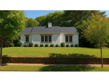 Charming single-story home featuring a well-manicured front yard and classic white exterior at 458 Shannon Sw Dr, Atlanta, GA 30310