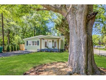 Charming home with a well-maintained front yard and mature trees offering shade and curb appeal at 2572 Bates Se St, Smyrna, GA 30080