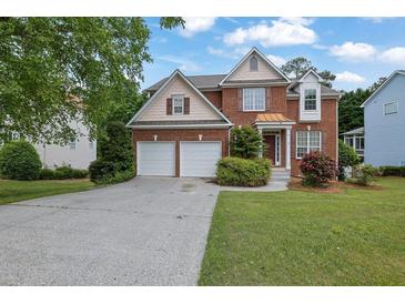 Charming brick home with a two-car garage, landscaped front yard, and inviting entrance at 2988 Belfaire Lake Dr, Dacula, GA 30019
